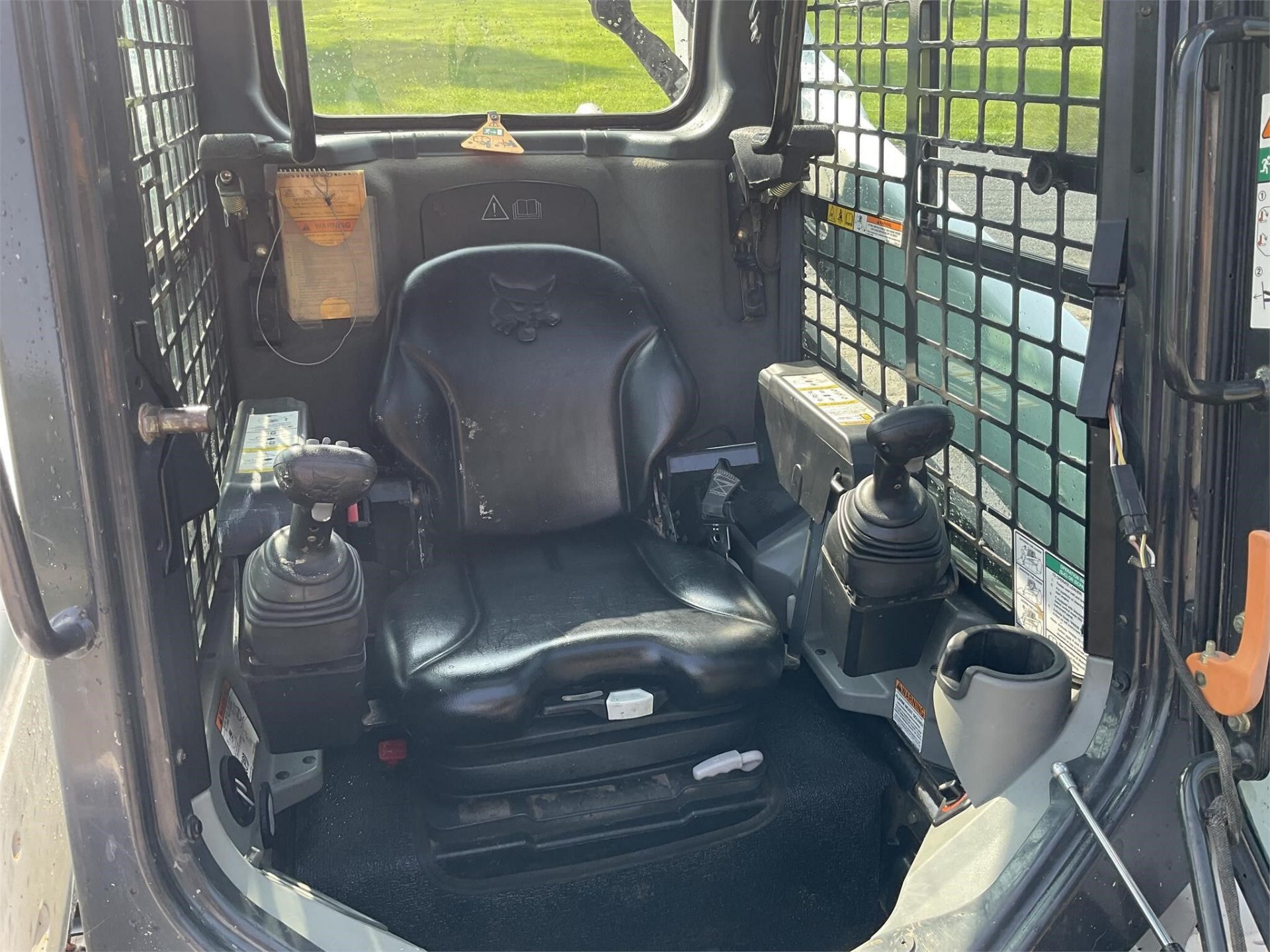 2014 Bobcat T590 — operator cab interior with joysticks